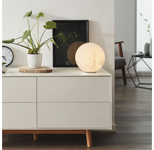 Lampe de chambre décorative sur une commode à tiroirs, avec une plante d''intérieur et une photo encadrée