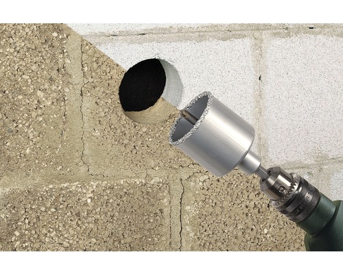 Perceuse avec trépan diamanté perçant un trou dans un mur