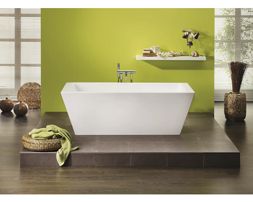 Salle de bain moderne avec baignoire îlot, étagère de rangement et éléments décoratifs.