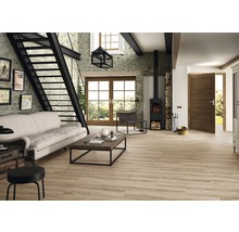 Heller Wohnraum mit Steintreppe, Kaminofen und Holzfliesenboden für ein wohnliches Ambiente