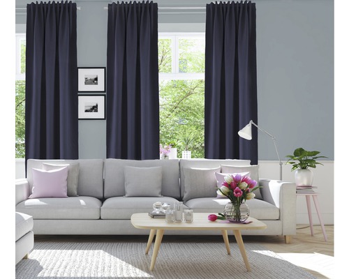 Wohnzimmer mit Sofa, Tisch und Fenstern mit Vorhängen