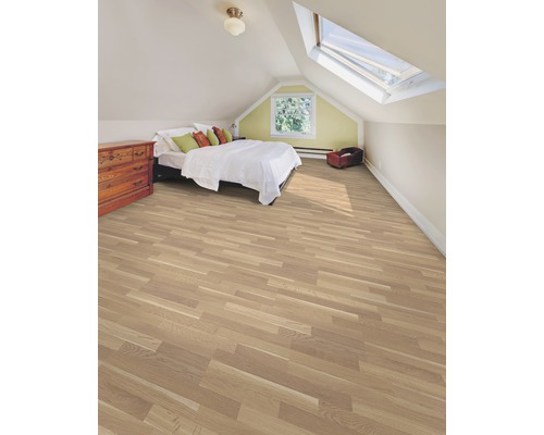 Schlafzimmer im Dachgeschoss mit Holzboden, Bett und Kommode