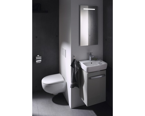 Salle de bain moderne avec WC suspendu, meuble sous-lavabo et miroir lumineux