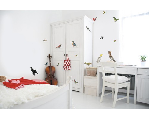 Chambre lumineuse avec lit, armoire, bureau et autocollants muraux avec des motifs d''oiseaux.