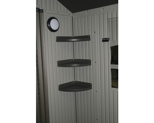 Vue intérieure d''une remise de jardin avec étagère d''angle et lumière