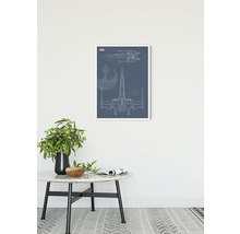 Image décorative avec un schéma du vaisseau spatial X-Wing dans un cadre blanc au-dessus d''une table.