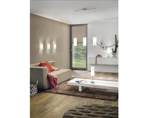 Wohnzimmer mit Sofa, Teppich, Couchtisch und verschiedenen Lampen zur Raumbeleuchtung.