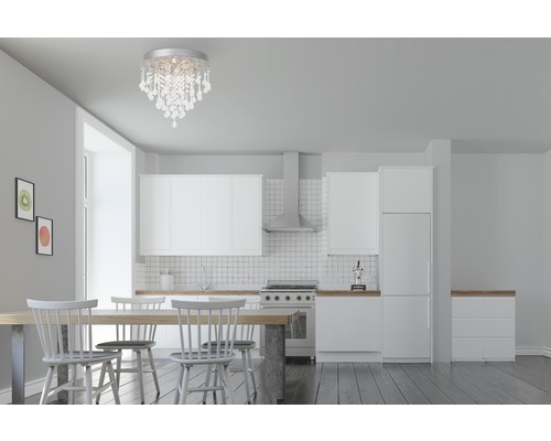 Salle à manger avec lustre, table et kitchenette