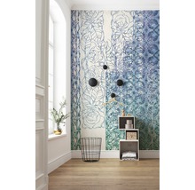 Pièce avec papier peint à motifs floraux, panier à linge métallique noir et étagère blanche.