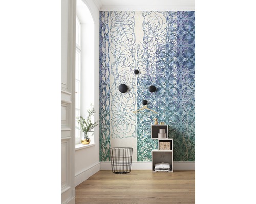 Pièce avec papier peint à motifs floraux, panier à linge métallique noir et étagère blanche.