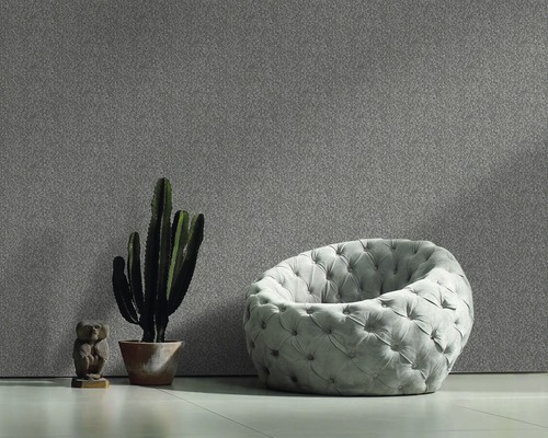 Innenraum mit gepolstertem Sessel, Kaktus im Topf und gemusterter Wand