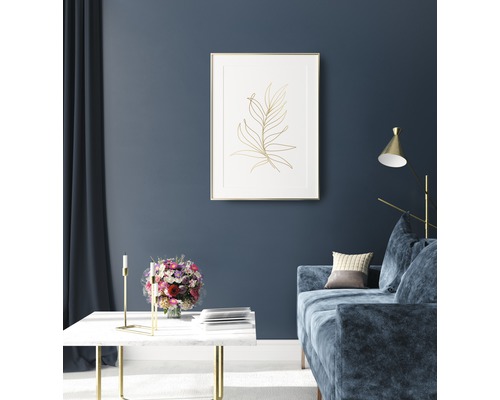 Wohnzimmer mit Couch, Tisch und gerahmtem Pflanzenbild