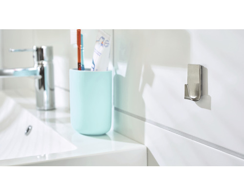 Scène de salle de bains avec lavabo, gobelet pour brosse à dents et crochet mural