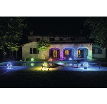 Maison illuminée avec piscine et guirlandes lumineuses de nuit