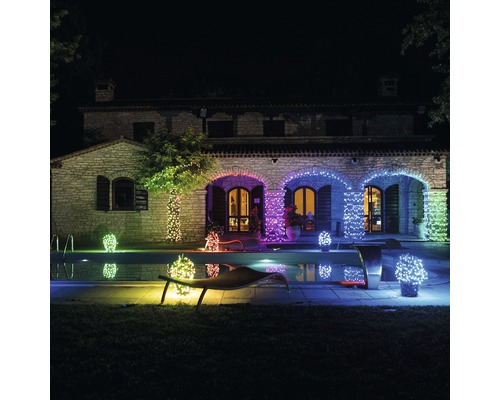 Maison illuminée avec des lumières LED près de la piscine