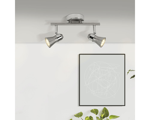 Deux spots argentés sur un rail métallique sont montés au plafond