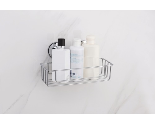 Étagère de douche en fil chromé avec trois flacons de shampooing sur un mur