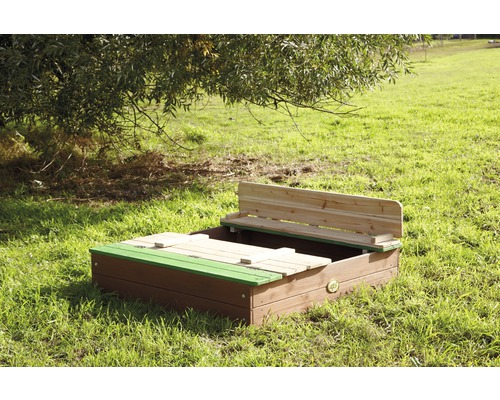 Sandkasten mit Sitzbank und Deckel auf einer Wiese