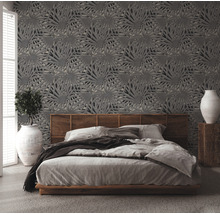 Chambre à coucher avec lit et papier peint à motif de feuilles