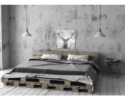 Bett aus Holzpaletten mit Matratze, Kissen und Hirschbild