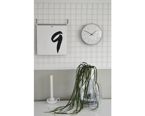 Décoration murale avec calendrier, horloge, bougie et plante en pot transparent