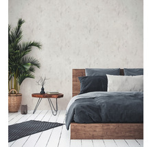 Schlafzimmer mit Bett, Nachttisch und Zimmerpflanze in einem Korb