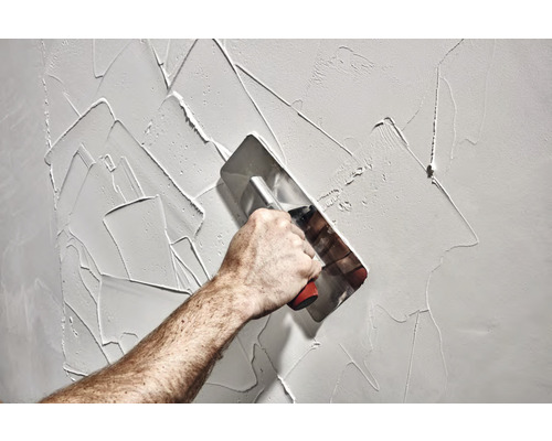 Application d''enduit sur un mur à l''aide d''une lisseuse