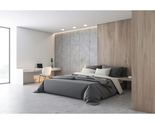 Chambre lumineuse avec lit double, bureau et mur en béton