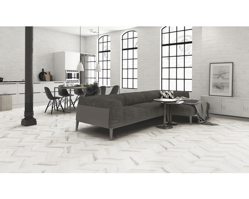 Salon lumineux avec canapé, table à manger et sol à chevrons