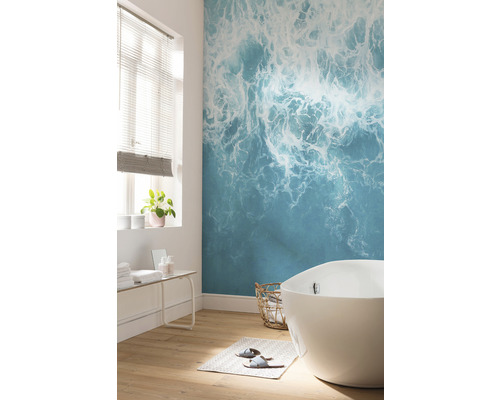 Badezimmer mit Badewanne und Fototapete mit Meeresmotiv