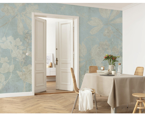 Salon avec papier peint à motifs floraux, table à manger et porte ouverte