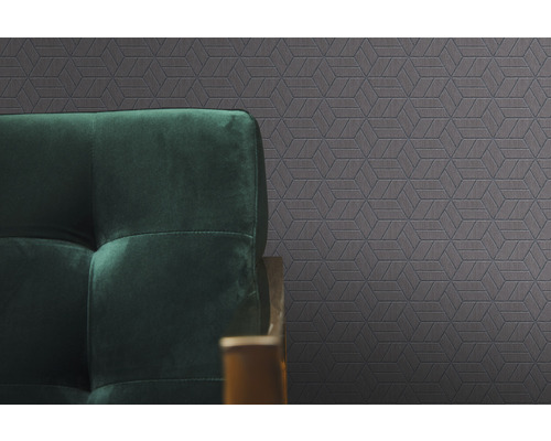 Papier peint à motifs avec formes géométriques et canapé vert foncé