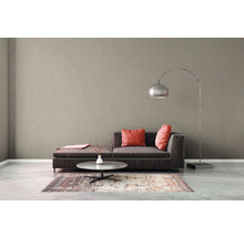 Wohnzimmer mit beiger Vliestapete, Sofa, Tisch und Stehlampe
