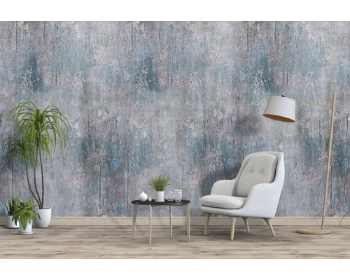 Salon avec fauteuil, lampadaire, table, plantes d''intérieur et papier peint mural imitation béton.