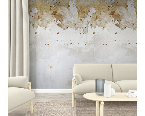 Wohnzimmer mit Couch, Sessel, Tisch und beschädigter Wand