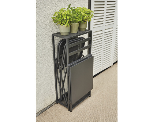 Table pliante et chaises pliantes dans une étagère, plus plantes