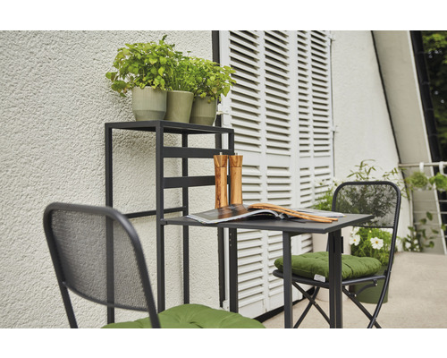 Scène de jardin avec table, chaises et étagère à plantes sur un balcon