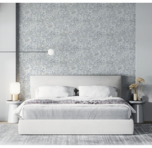 Chambre à coucher avec lit double, tables de chevet et papier peint à motifs végétaux