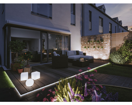 Beleuchteter Garten mit Terrasse, Loungemöbeln und Blumenbeet