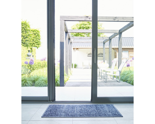 Tapis d''entrée devant une porte de patio donnant sur une terrasse avec pergola