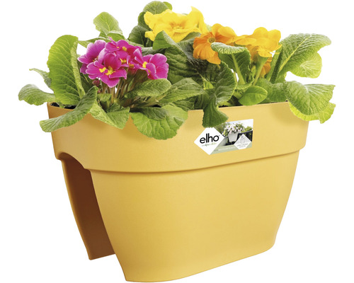 Gelber Balkonkasten mit bunten Primeln