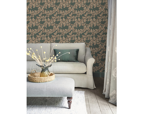 Salon avec papier peint à feuilles vertes, canapé et ottoman