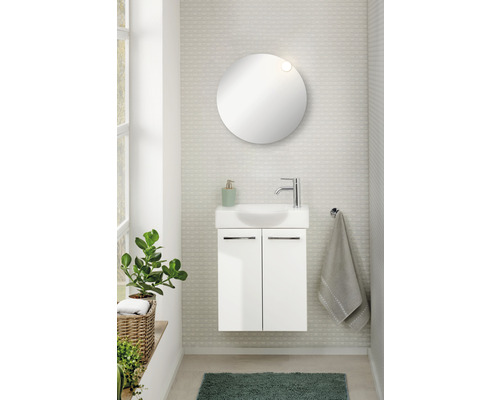 Salle de bains moderne avec meuble sous-lavabo, miroir rond et plante d''intérieur