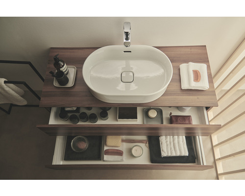 Meuble-lavabo avec système de tiroirs ouverts et vasque à poser dans la salle de bains