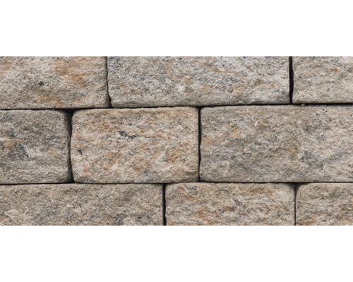 Nahaufnahme einer Mauer aus beigefarbenen Pflastersteinen