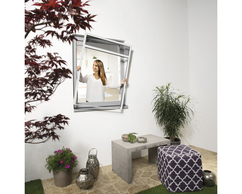 Scène de terrasse avec une fenêtre tenue par une femme et des meubles de jardin