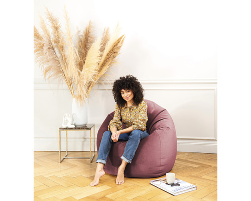 Frau sitzt auf einem Sessel im Zimmer