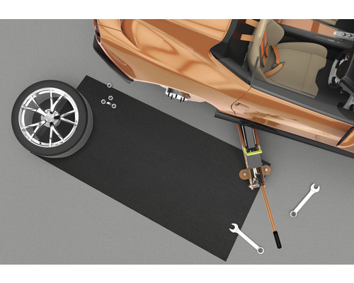 Scène avec cric, pneu, outil et tapis de protection
