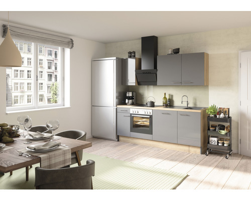 Helle Küche mit Esstisch, Stühlen, Küchenzeile mit Elektrogeräten und Küchenwagen.