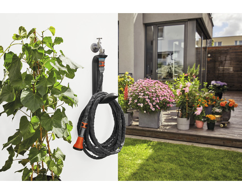 Gartenszene mit Pflanze, Wasserhahn und Gartenschlauchhalter mit Schlauch